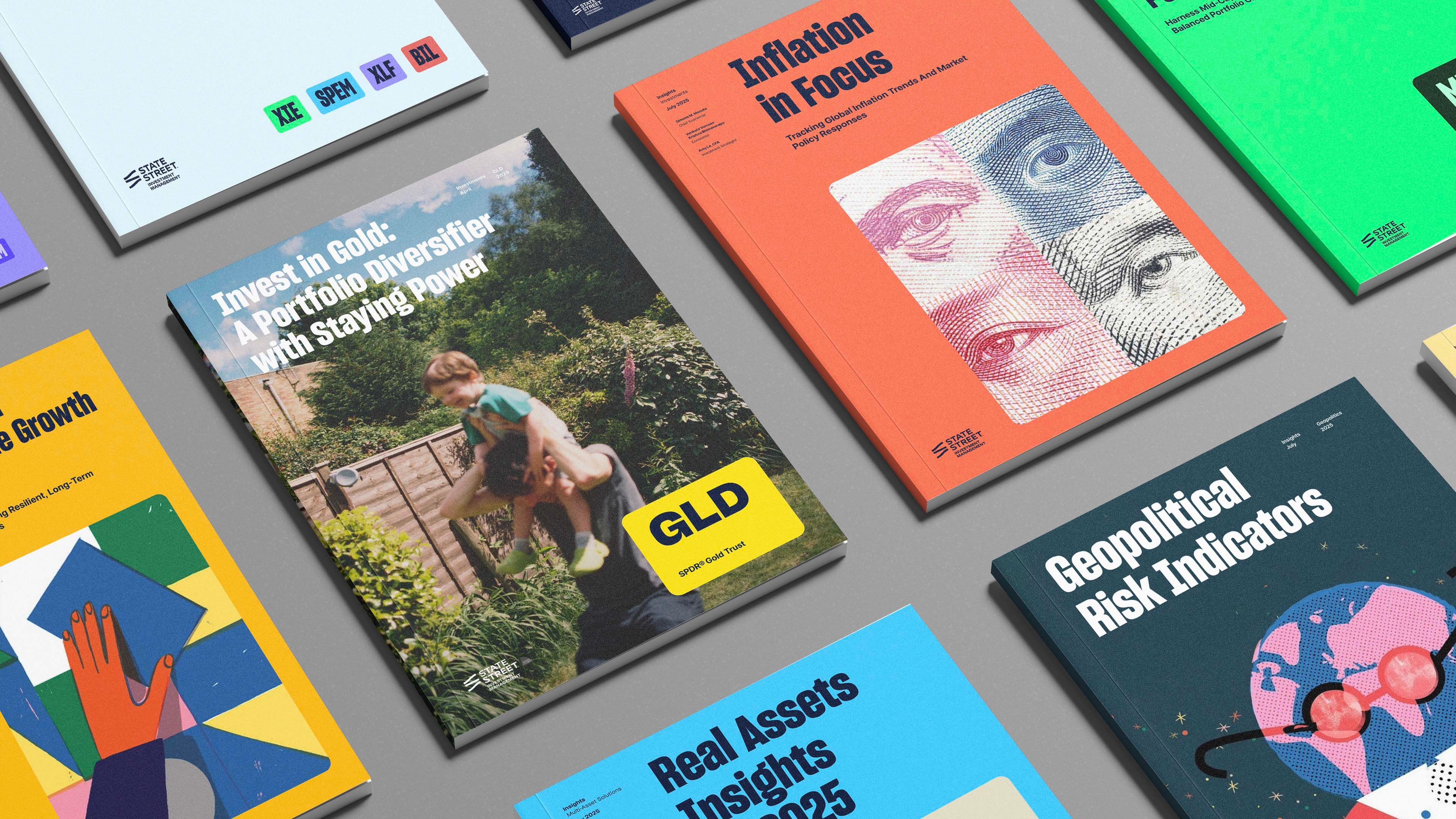 Flatlay of nine publication covers in varied colors, including GLD, ETF Impact Report, and Geopolitical Risk Indicators