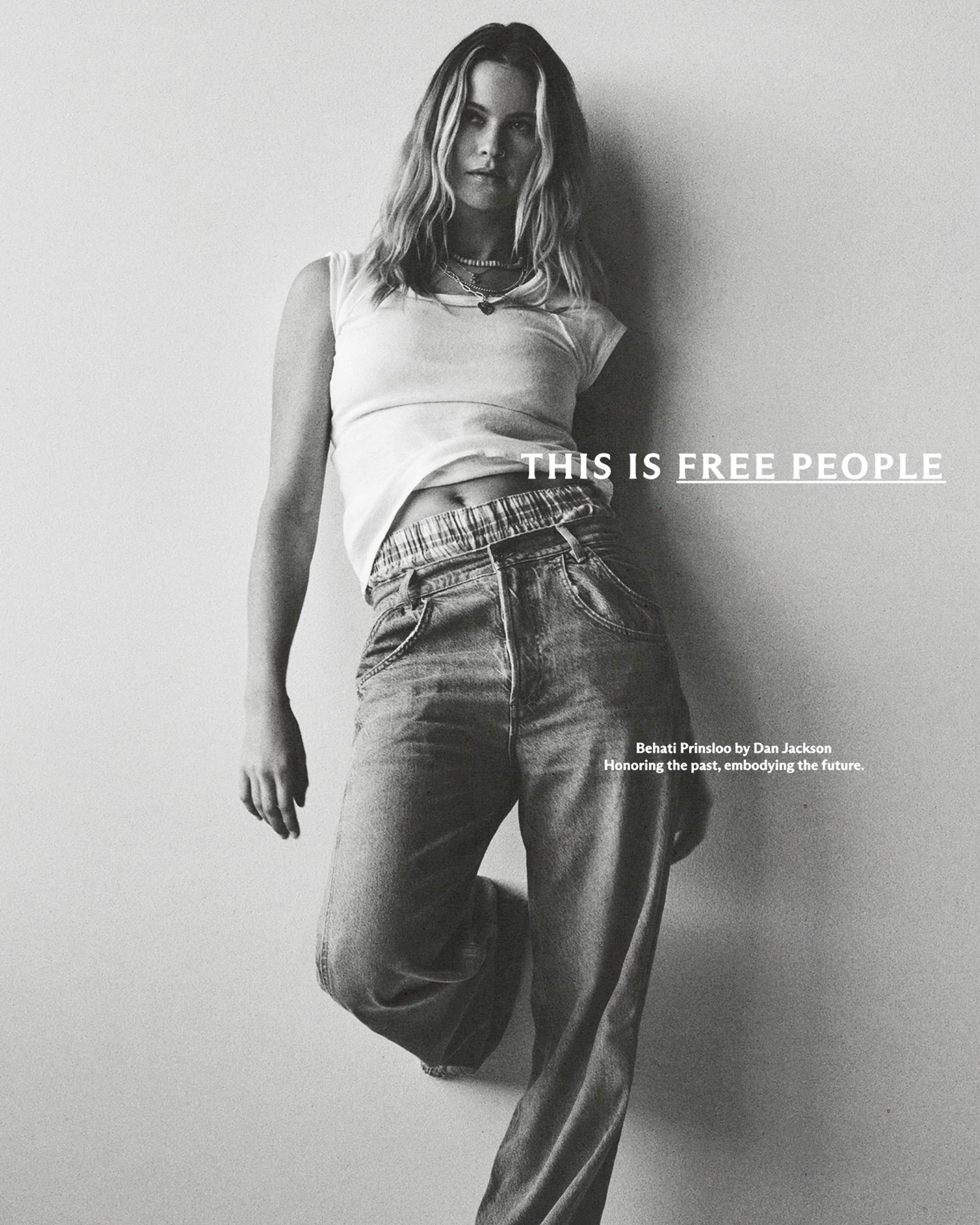 This Is Free People Campaign: B&W Behati Prinsloo portrait — typography overlaid on model in crop top + wide-leg jeans