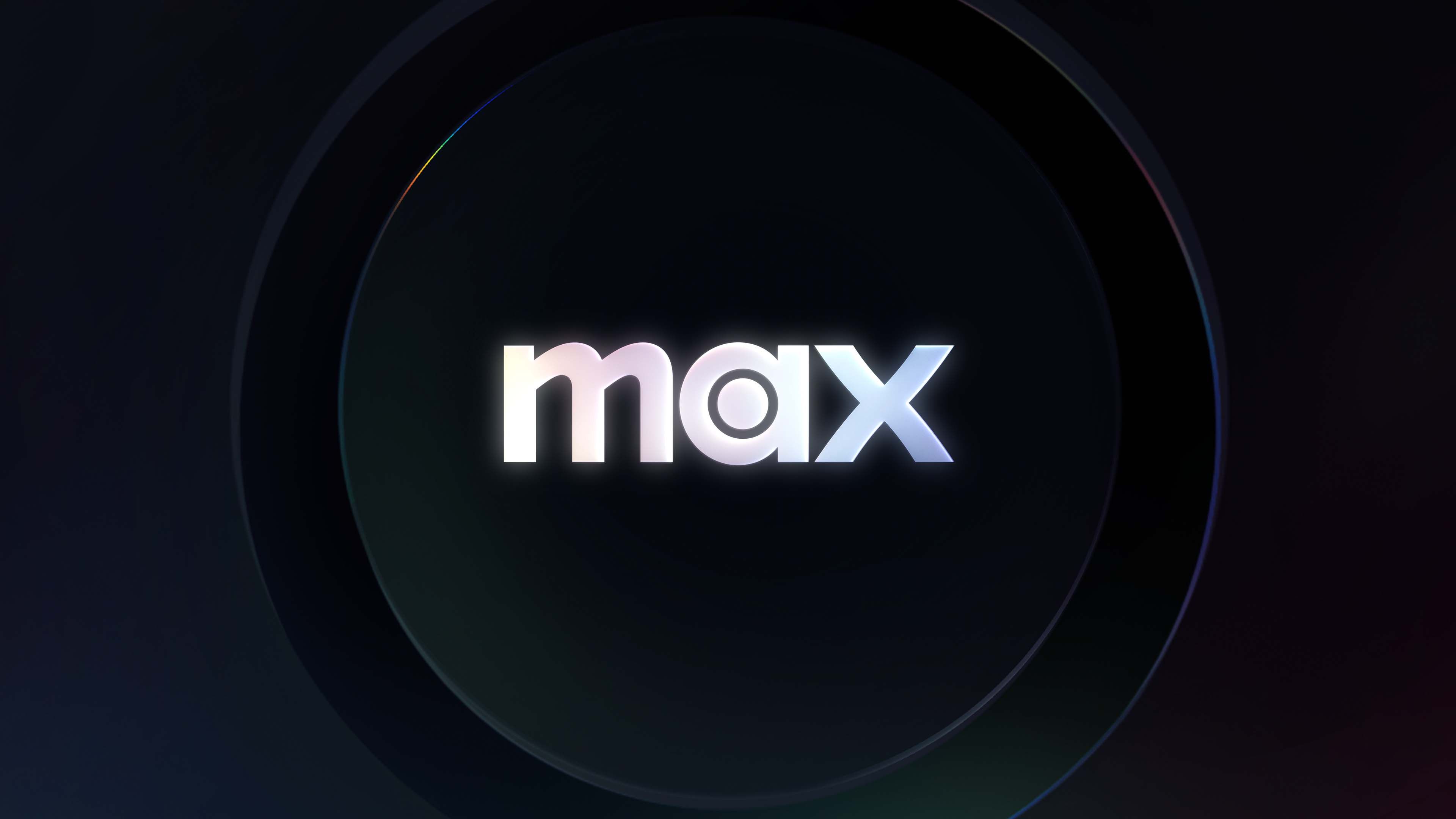 Max streaming service logo: white lowercase wordmark centered in a dark circular emblem with iridescent edge lighting.