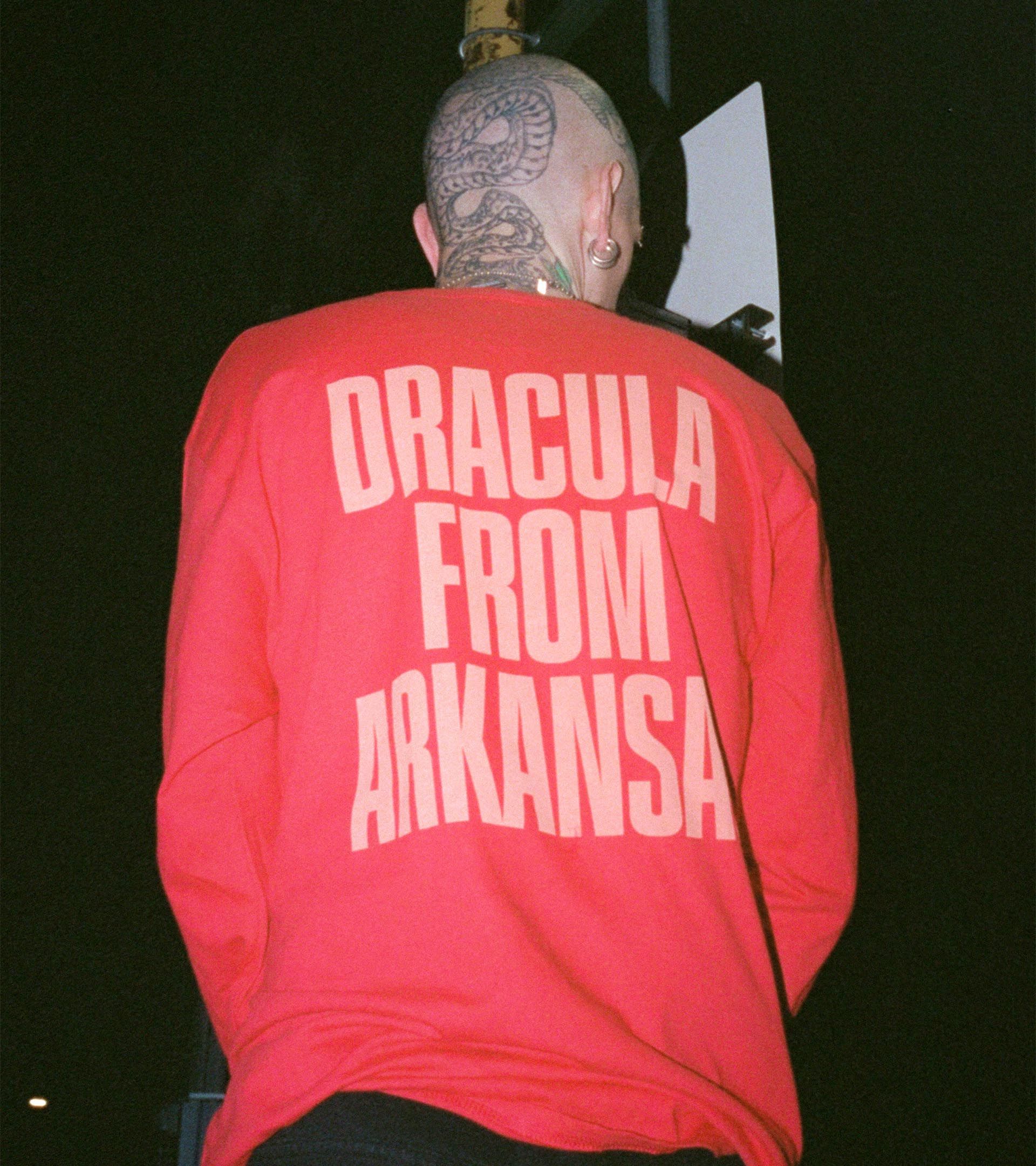 Trevor Powers (Youth Lagoon) on stage, back view: red 'Dracula From Arkansas' long-sleeve, tattooed head