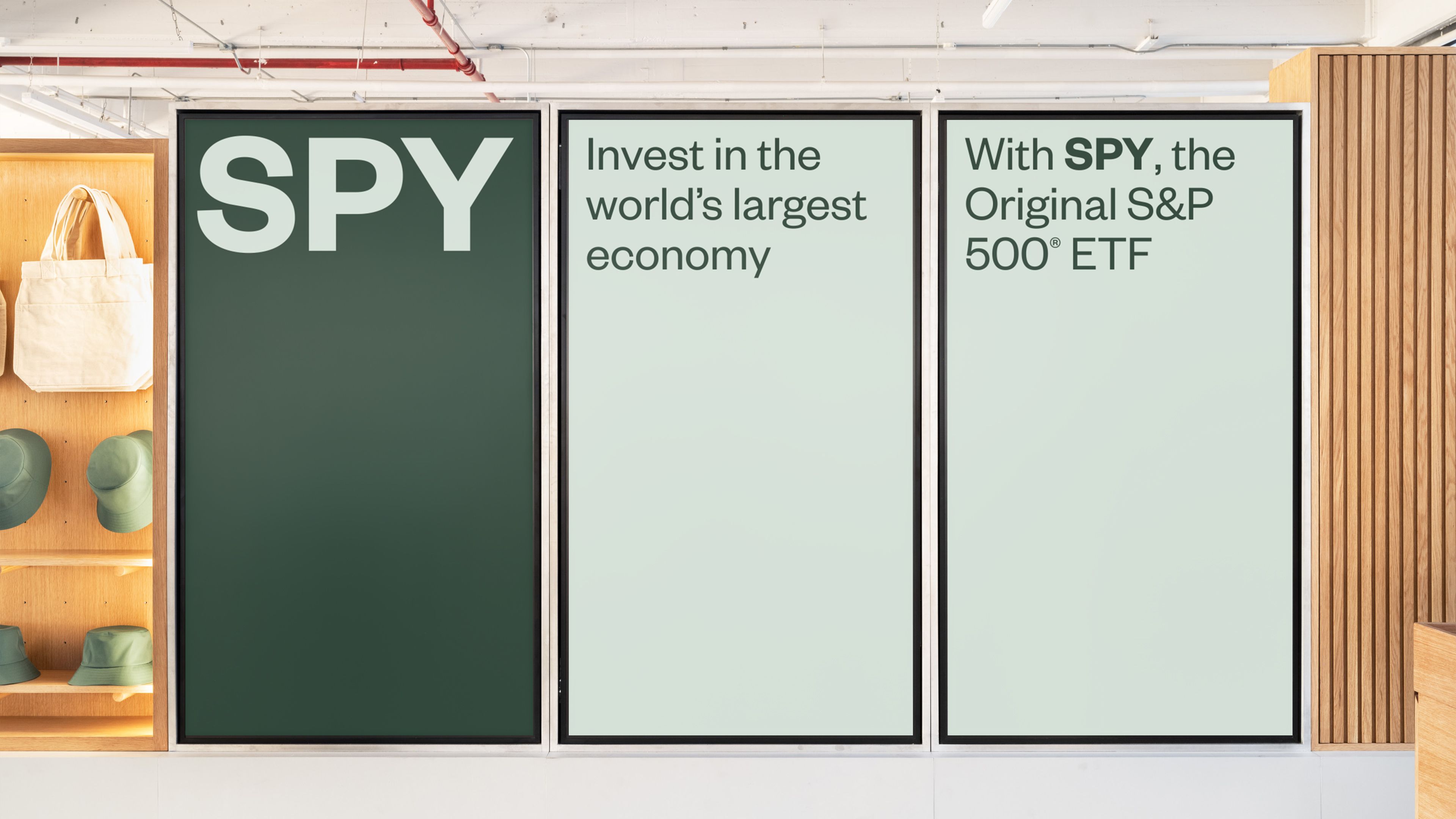 Booth screen panels: "SPY" ticker on dark green, "the Original S&P 500® ETF" on light green in Founders Grotesk
