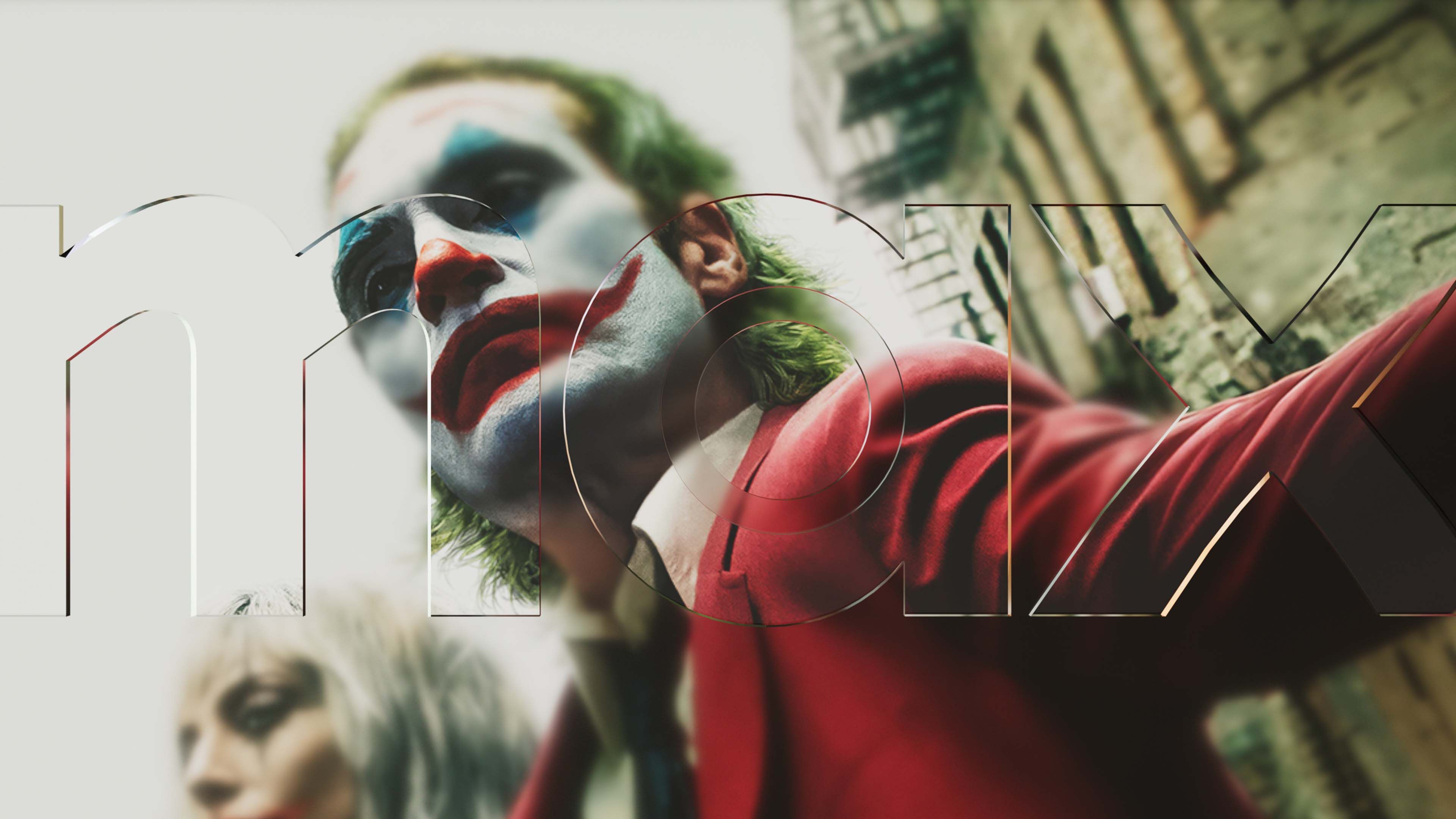 Glass Max wordmark overlaid on a film still from Joker, showing the character in red suit and clown makeup.