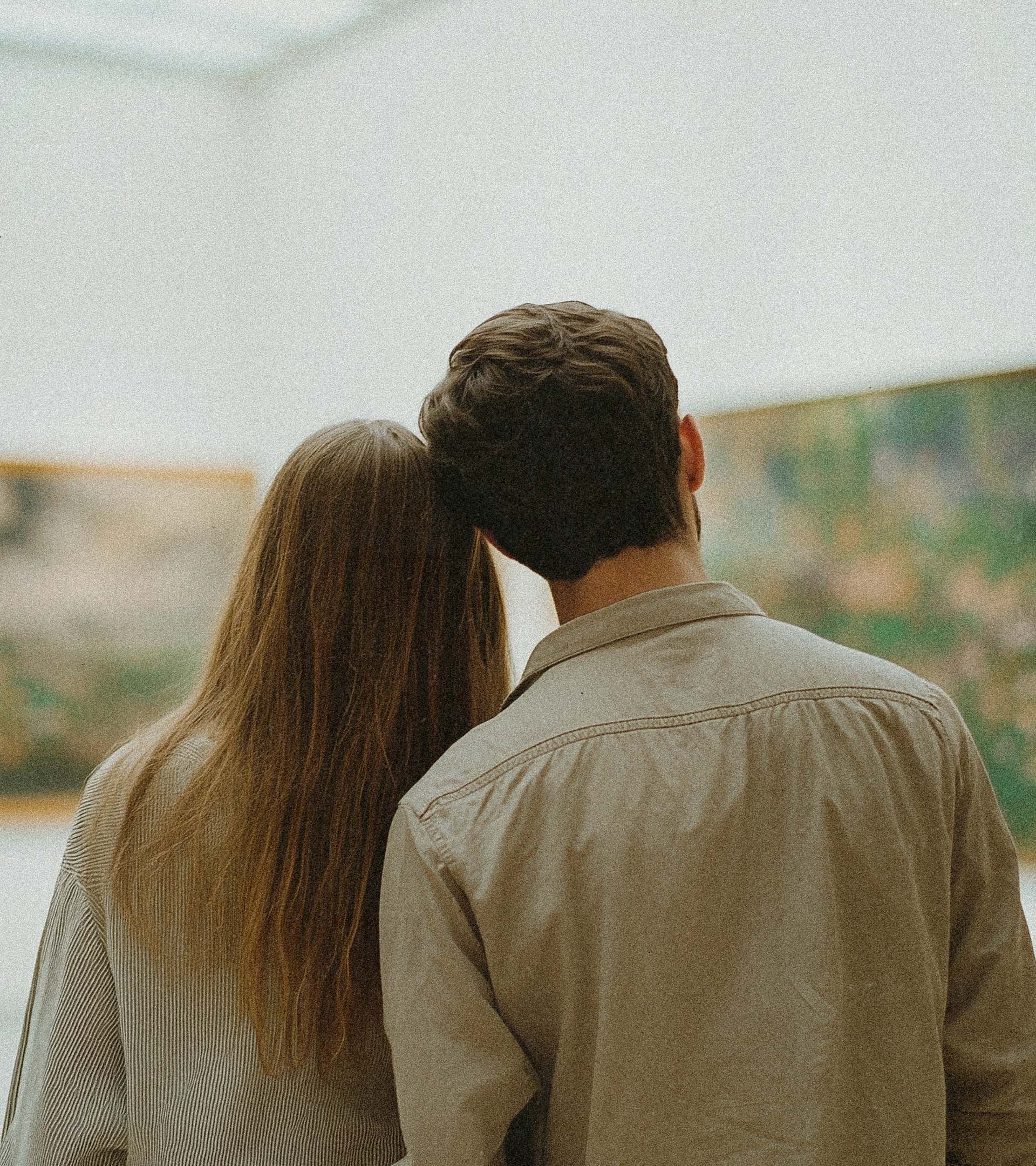 Couple viewed from behind, leaning together before large impressionist painting at the MoMA
