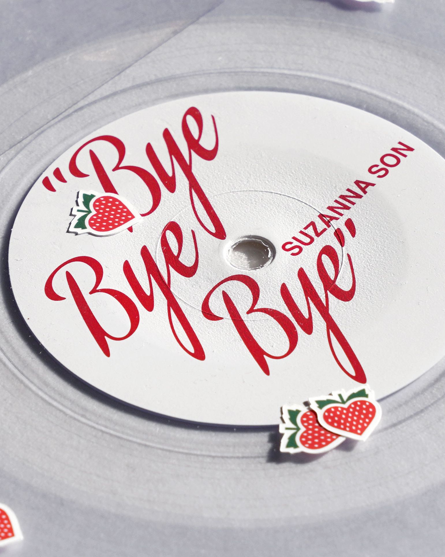 Red Rocket "Bye Bye Bye" / Suzanna Son clear vinyl 7": white label, Sean Baker red script, loose strawberry heart stickers