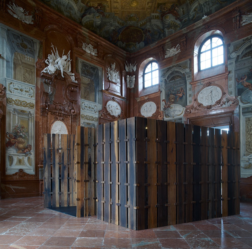 An ornamental room with curved windows and a wooden structure in the middle