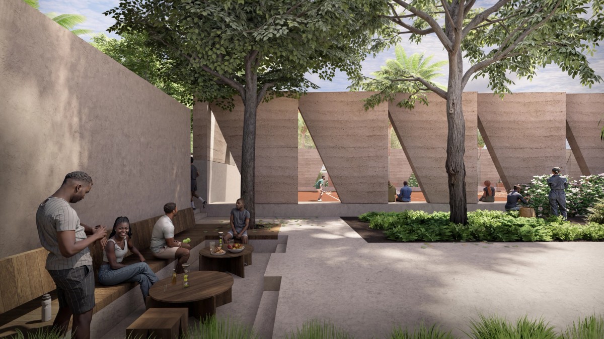People relax and socialize in a shaded seating area surrounded by trees and greenery, with refreshments set out on low wooden tables. Through geometric openings in the earthen wall, others can be seen playing tennis on a sunlit court, blending leisure and community in a serene, modern space.