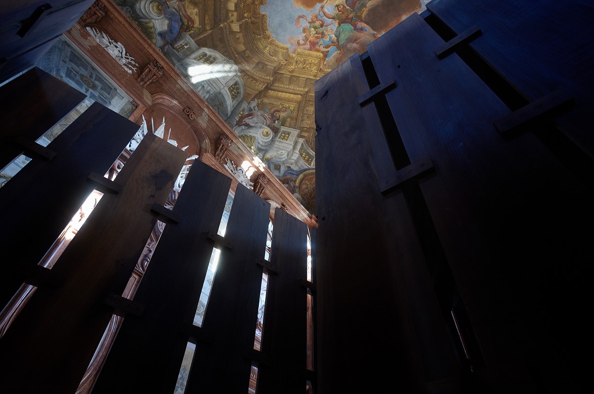 A photo from below of a painted ceiling and a wooden structure
