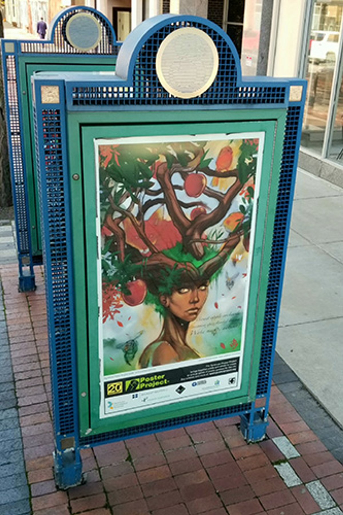 A kiosk with a poster of a tree fantasy-like creature