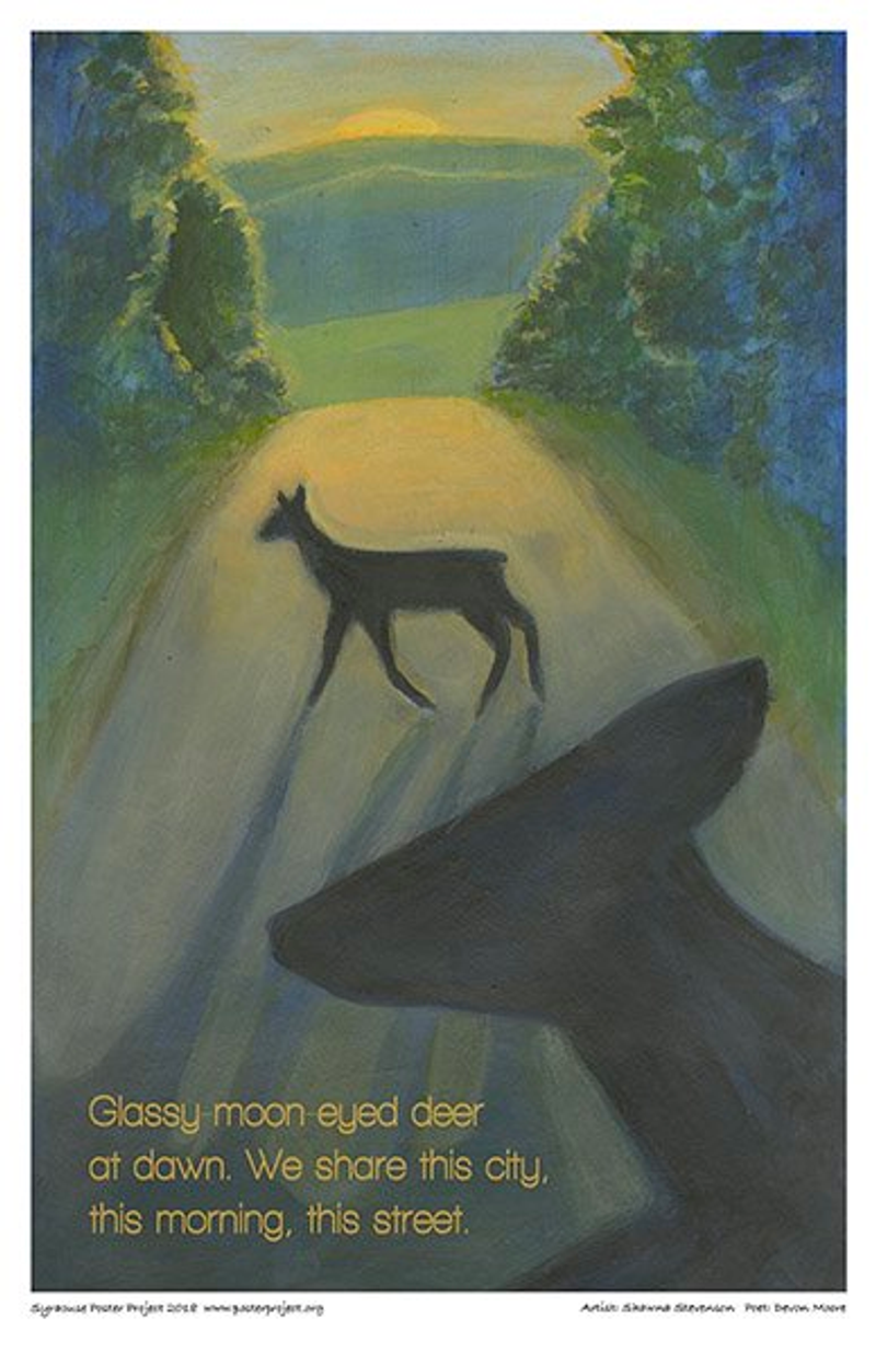 The silhouette of a deer crossing an empty street at dawn