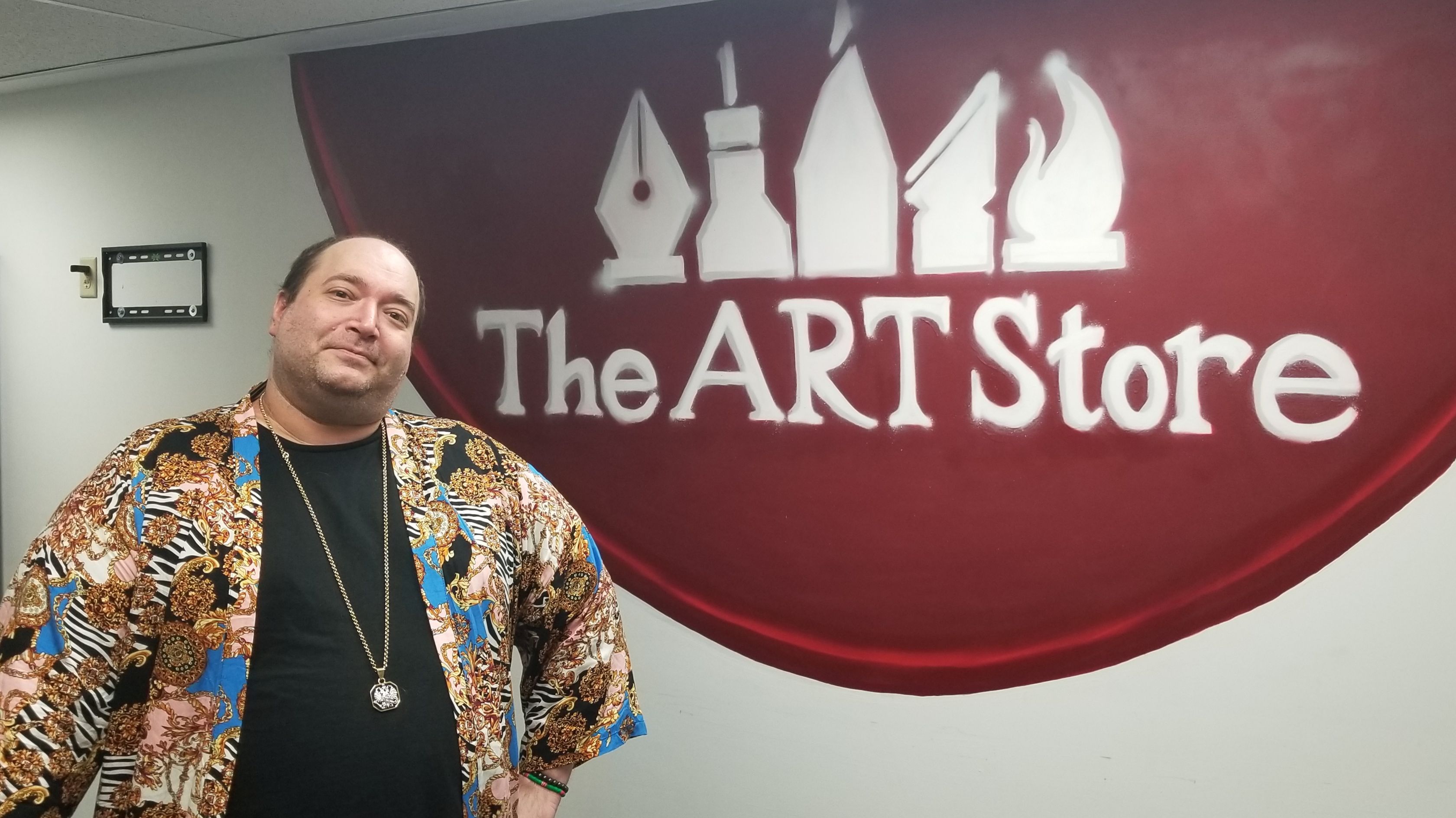 Art Store Manager Joe Von Souder and logo for The Art Store