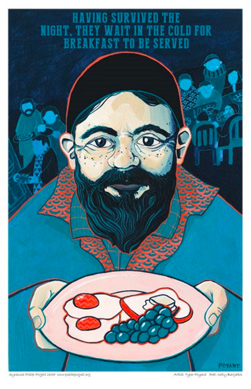 A bearded man holds a plate of food with other people eating behind him