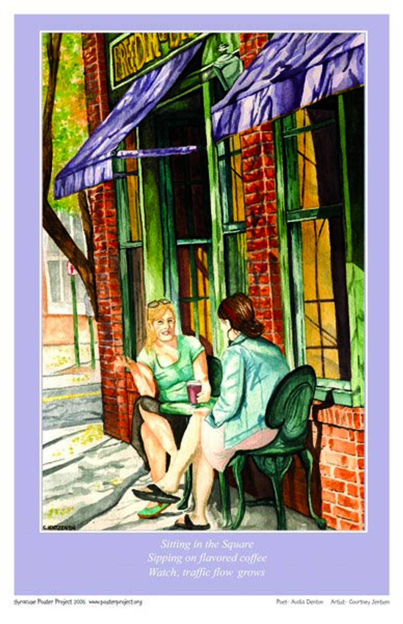 Two woman talk and drink coffee at a small table on the sidewalk outside a coffee shop