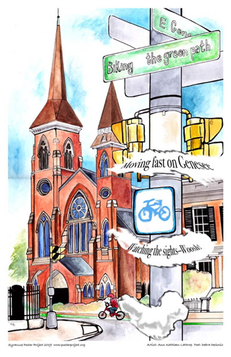 A cyclist rides down a street past a house and a church
