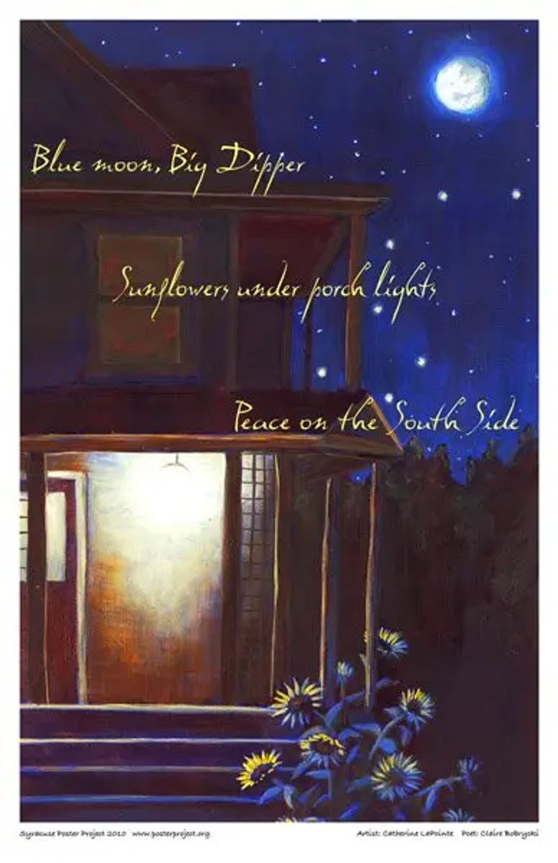 A porch light shines against nearby sunflowers beneath a night sky