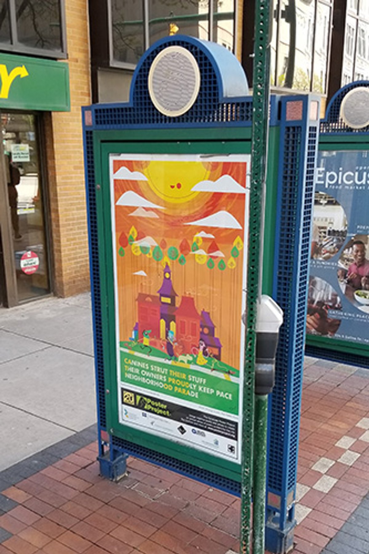 A kiosk behind another kiosk near a Subway building