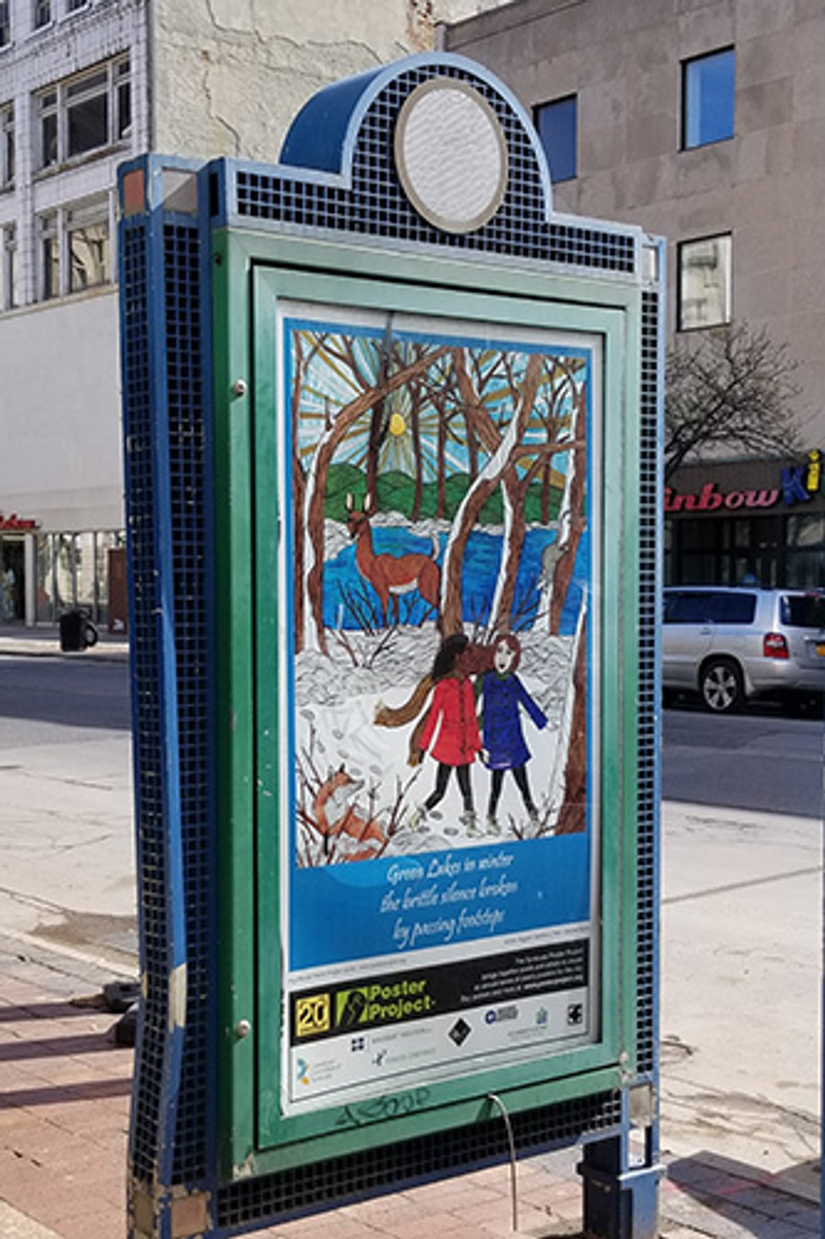 A winter poster in a kiosk on a bright sunny day