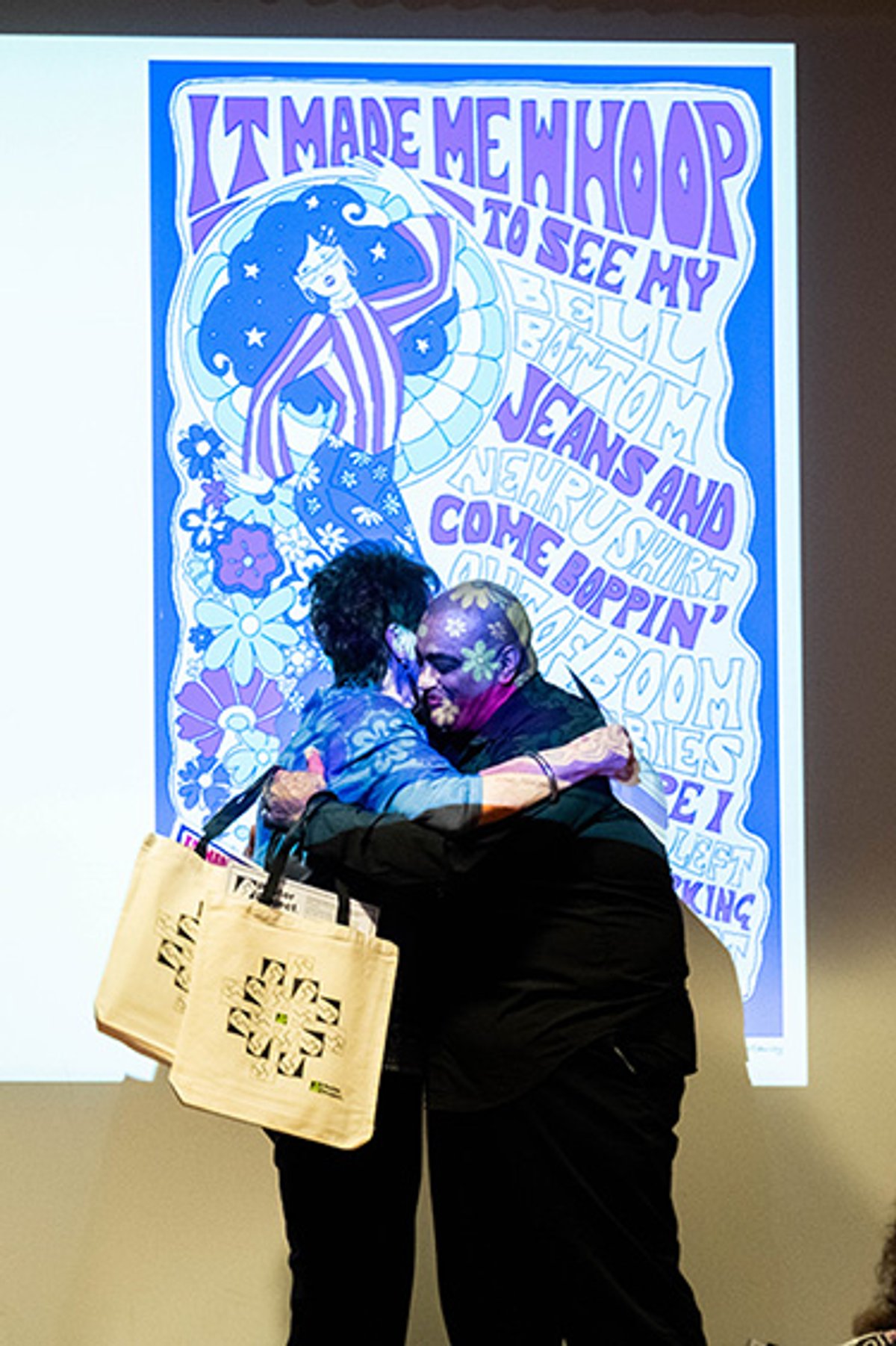 Poet Ellen McCauley embracing board member Richard Rodriquez