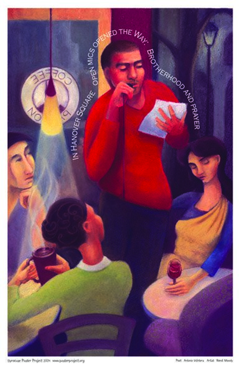 A man reads from a piece of paper in his hand into a mic for a small audience in a coffee shop