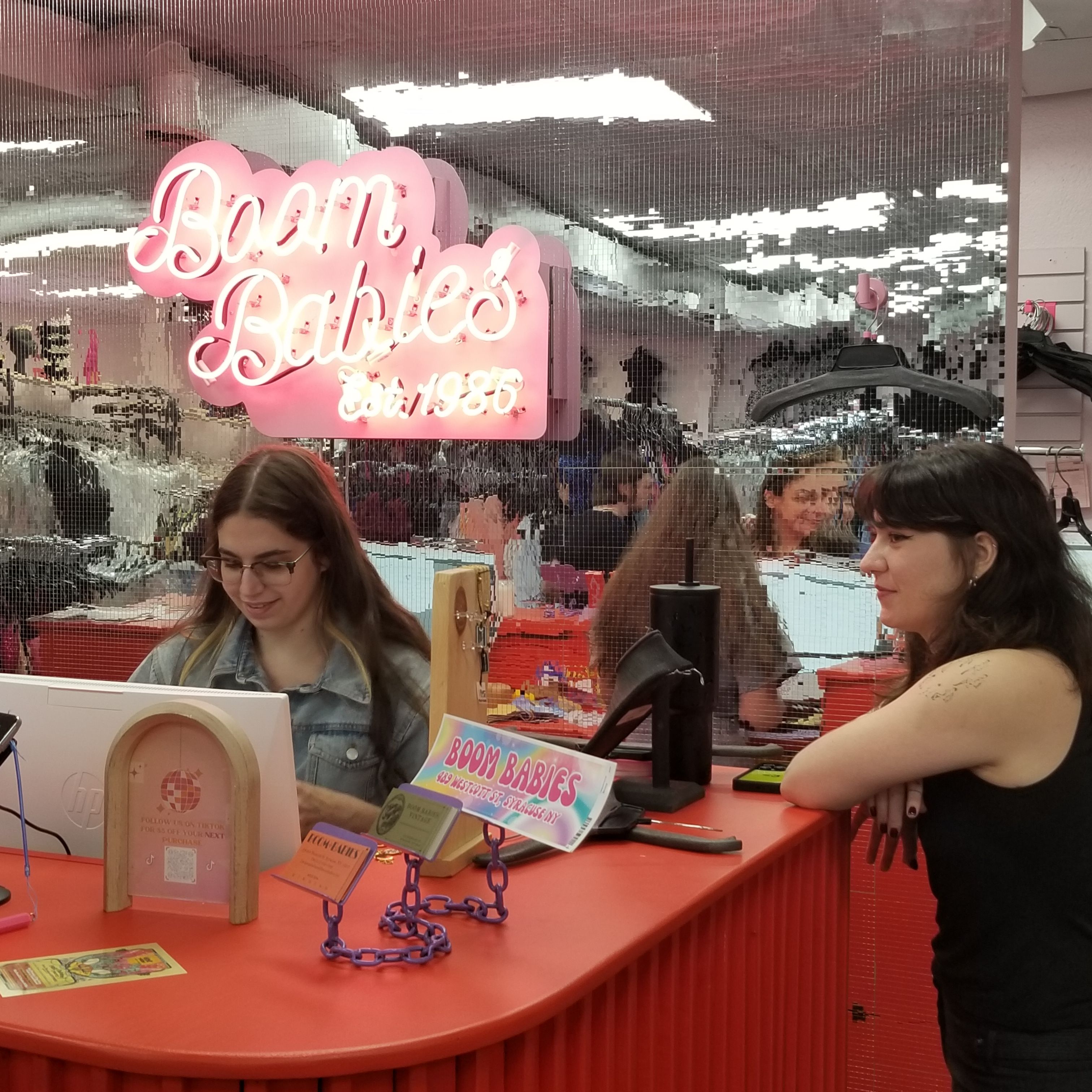 Two workers at Boom Babies checkout counter