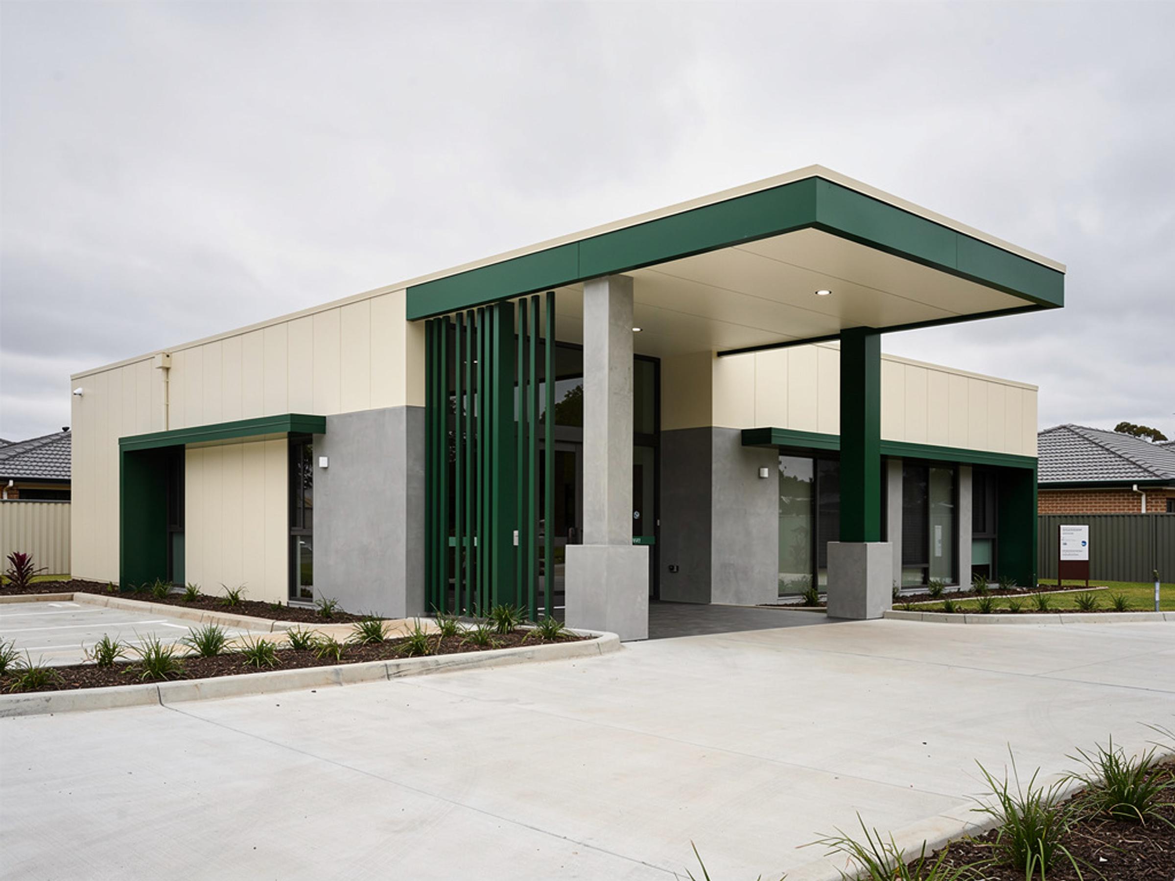 A completed suburban medical centre with an entry canopy, illustrative of the building type