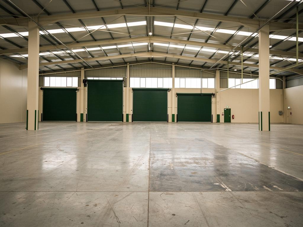 An empty warehouse after racking removal, illustrative of the building type