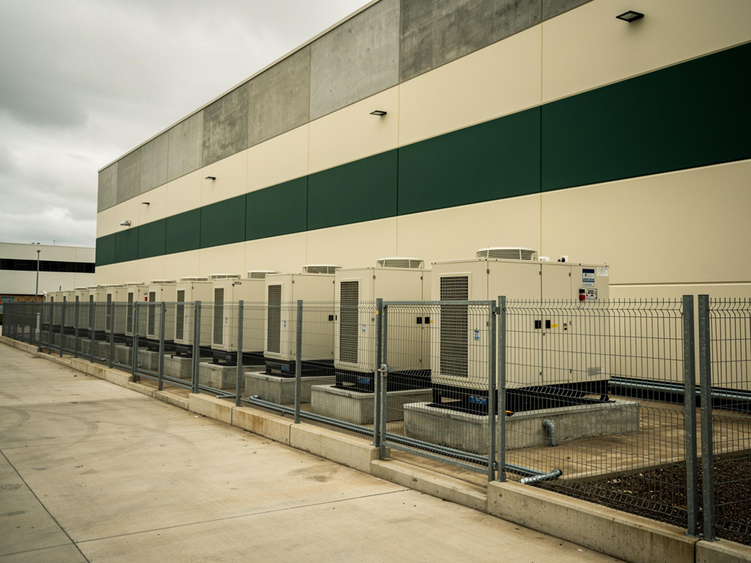 Standby generators and cooling units beside a data hall, illustrative of the building type