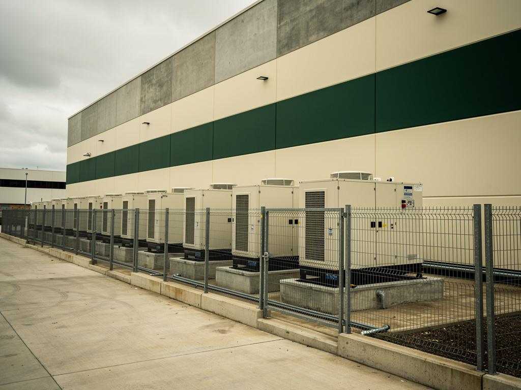 Standby generators and cooling units beside a data hall, illustrative of the building type