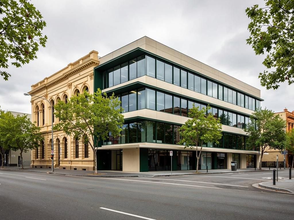 A completed low-rise commercial building on a tree-lined city street, illustrative of the building type