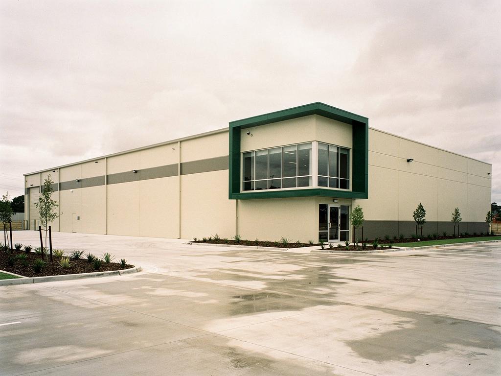 A newly completed greenfield warehouse with a corner office, illustrative of the building type
