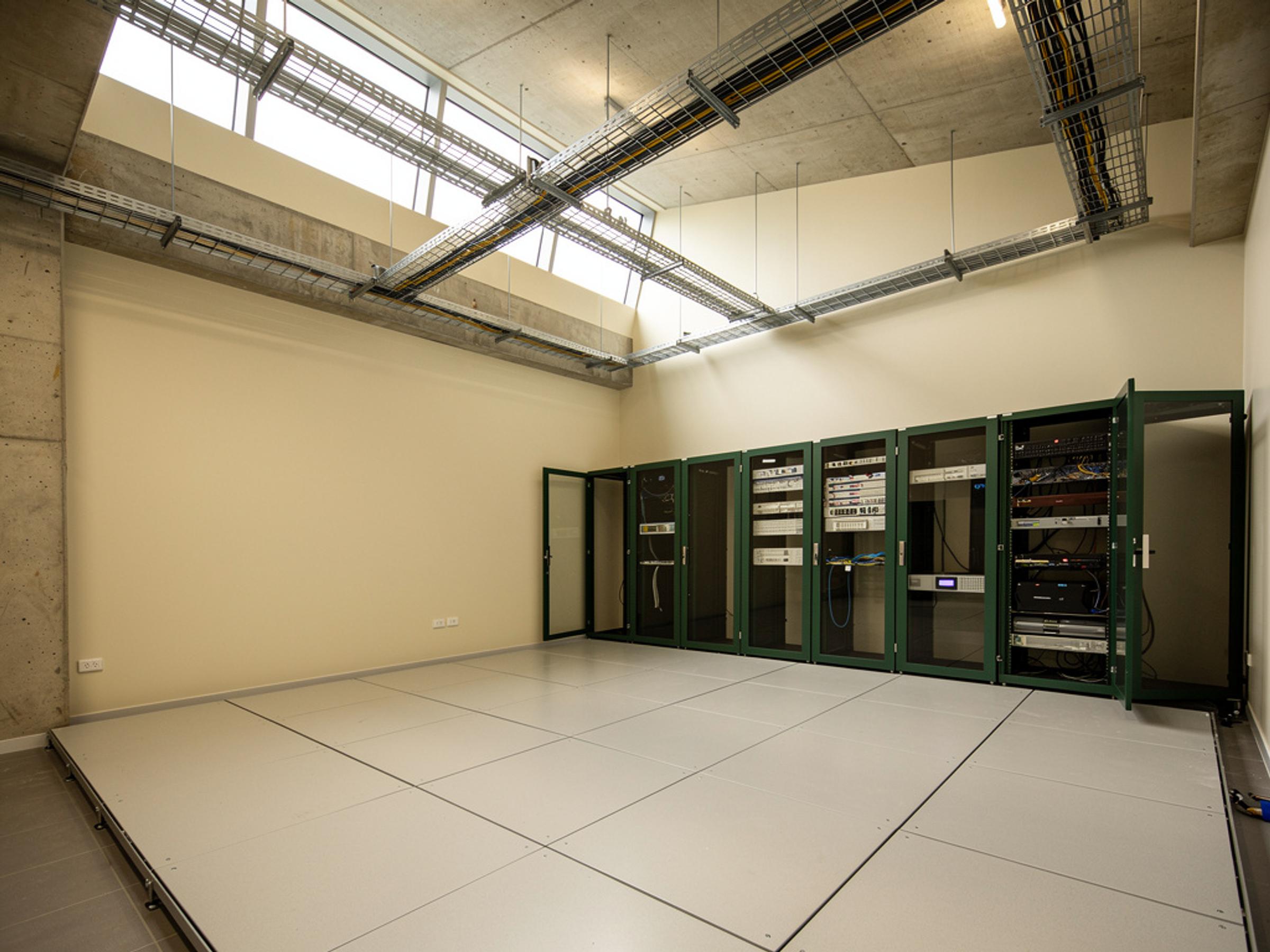 A completed communications room with racks and cable trays, illustrative of the building type