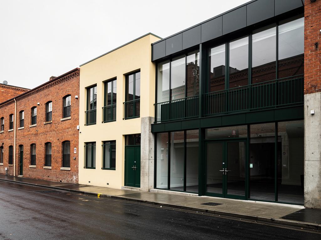 A completed commercial building in an inner-city brick and glass streetscape, illustrative of the building type