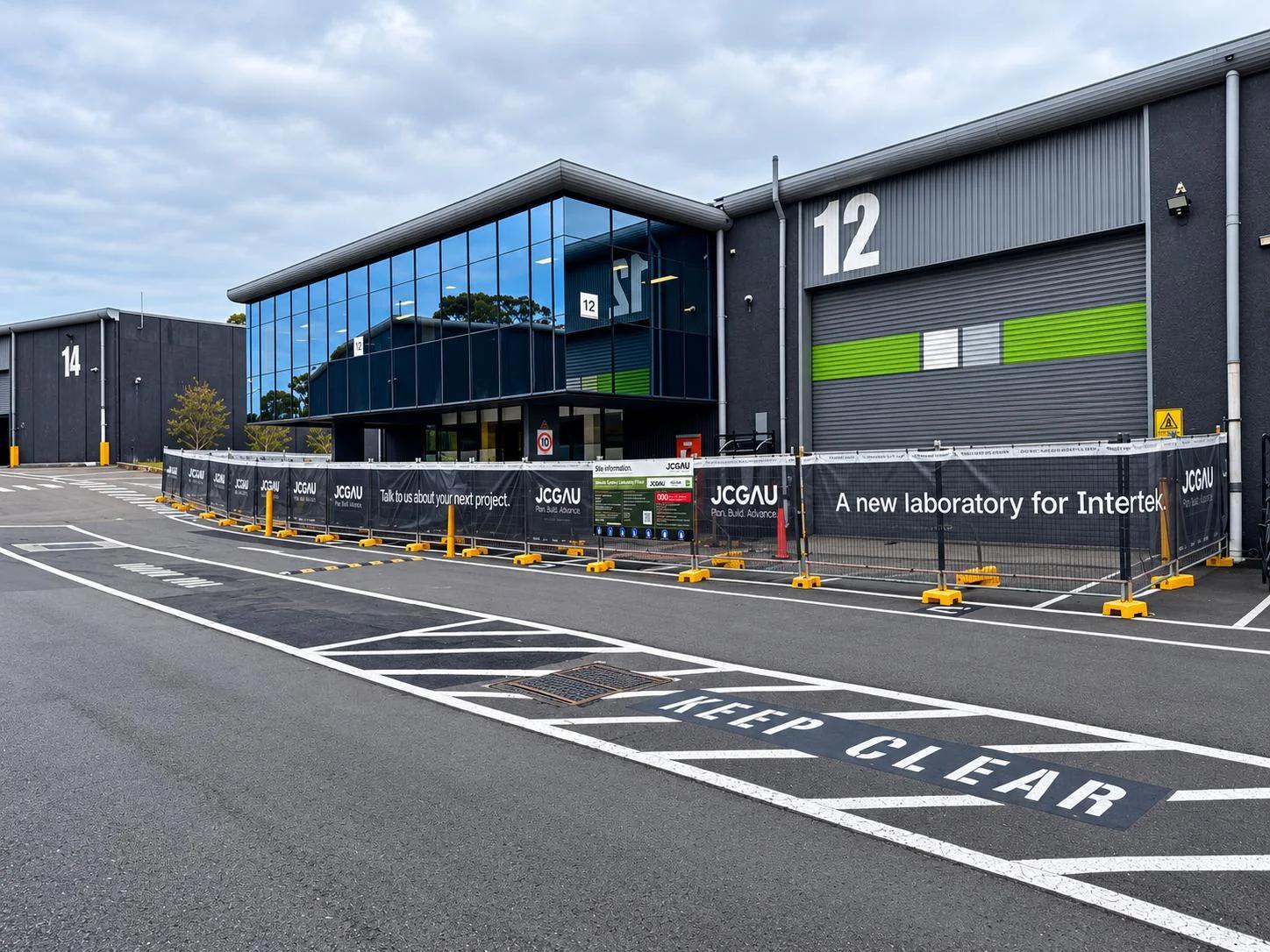 Intertek Sydney Laboratory, Botany NSW, during construction with JCGAU site hoarding and the estate loading zone kept clear
