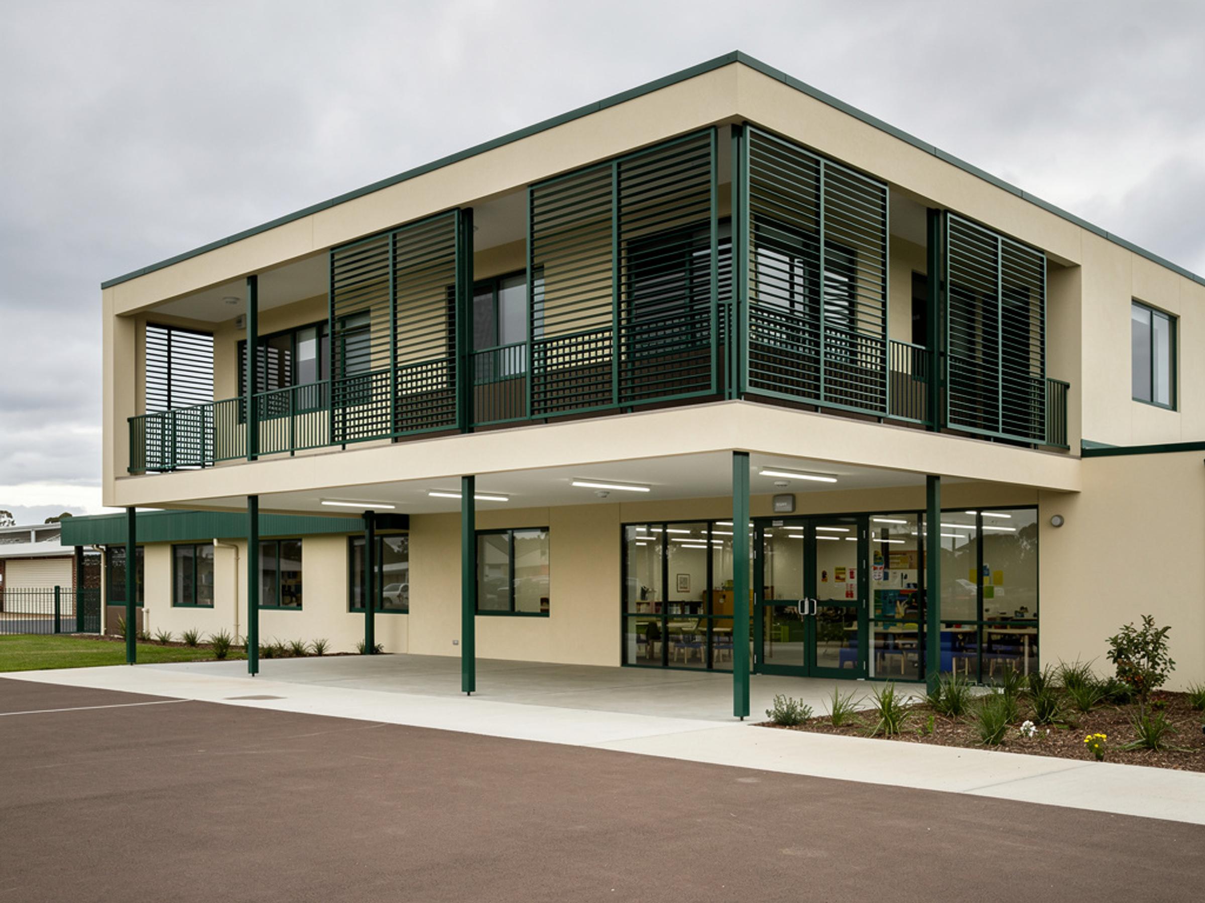 A completed school classroom building with a covered outdoor learning area, illustrative of the building type