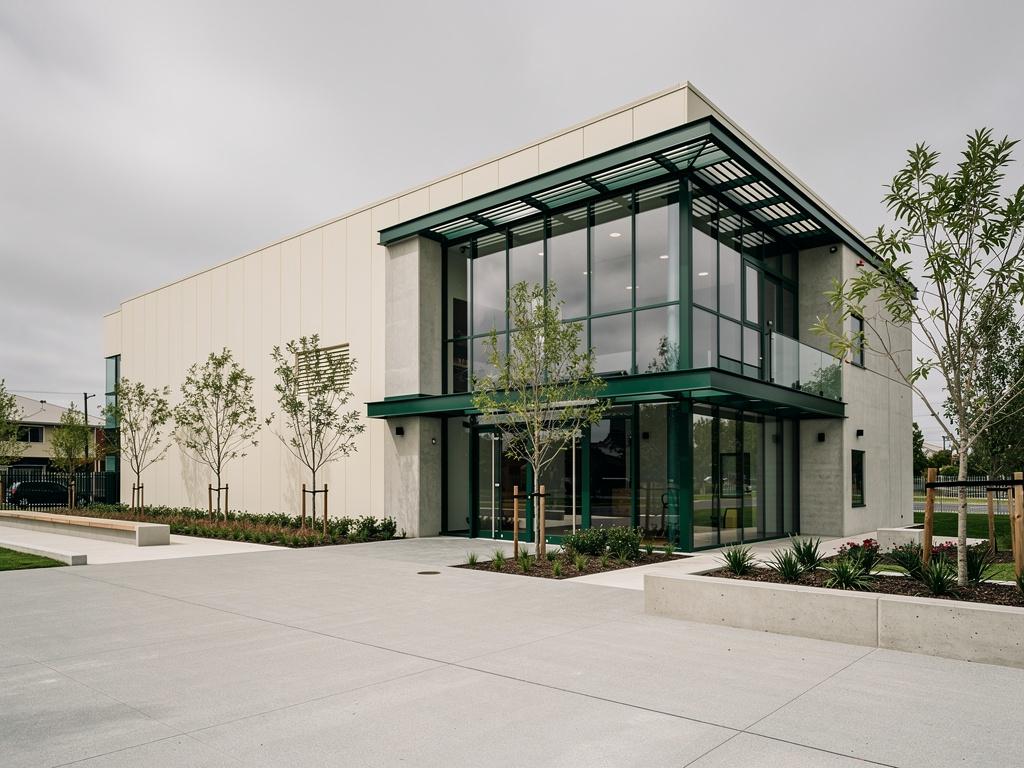 A newly completed commercial building with a clean forecourt, illustrative of the building type