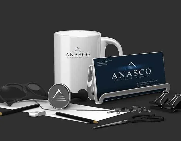Anasco Corporate Services lietvedības materiālu vizualizācija — krūze, vizītkarte un nozīmīte