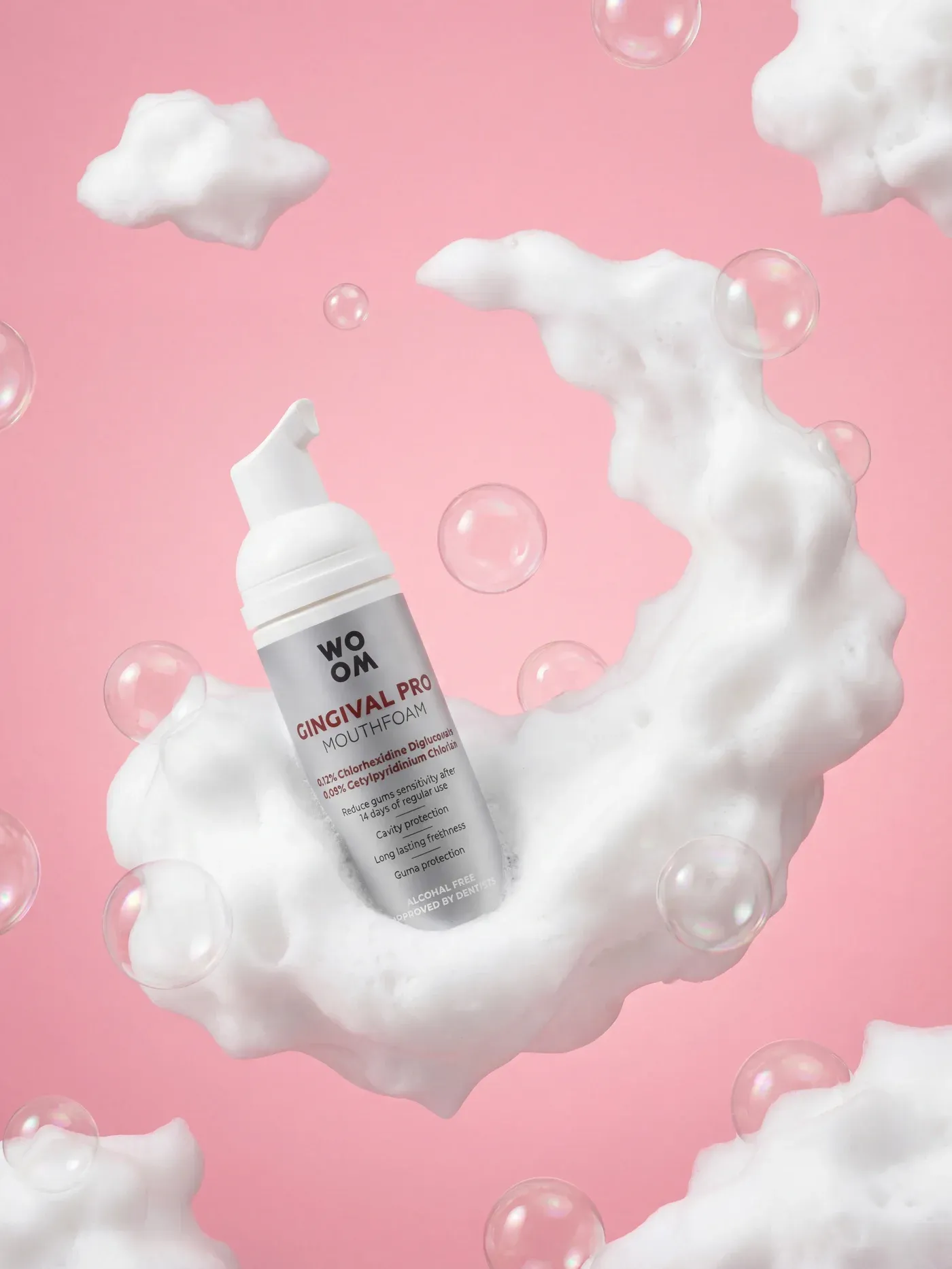 AI-generated lifestyle photo of the Woom Gingival Pro mouthfoam bottle surrounded by soap foam and bubbles on a pink background