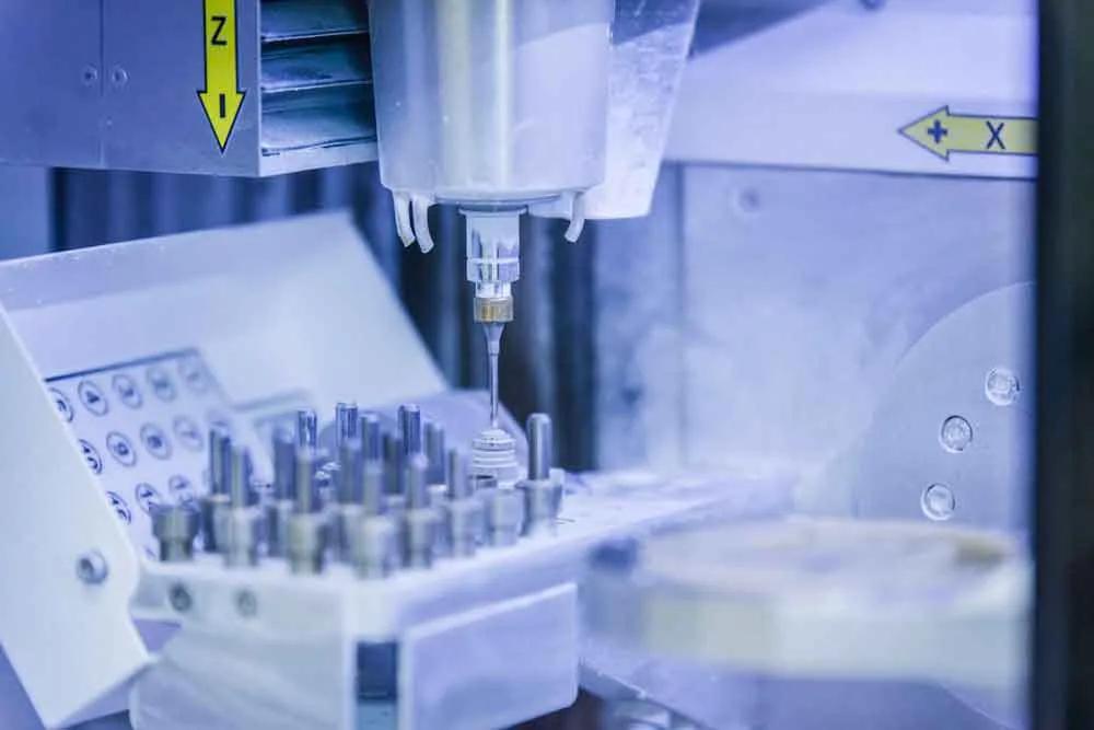 Close-up of laboratory automation equipment with a robotic arm