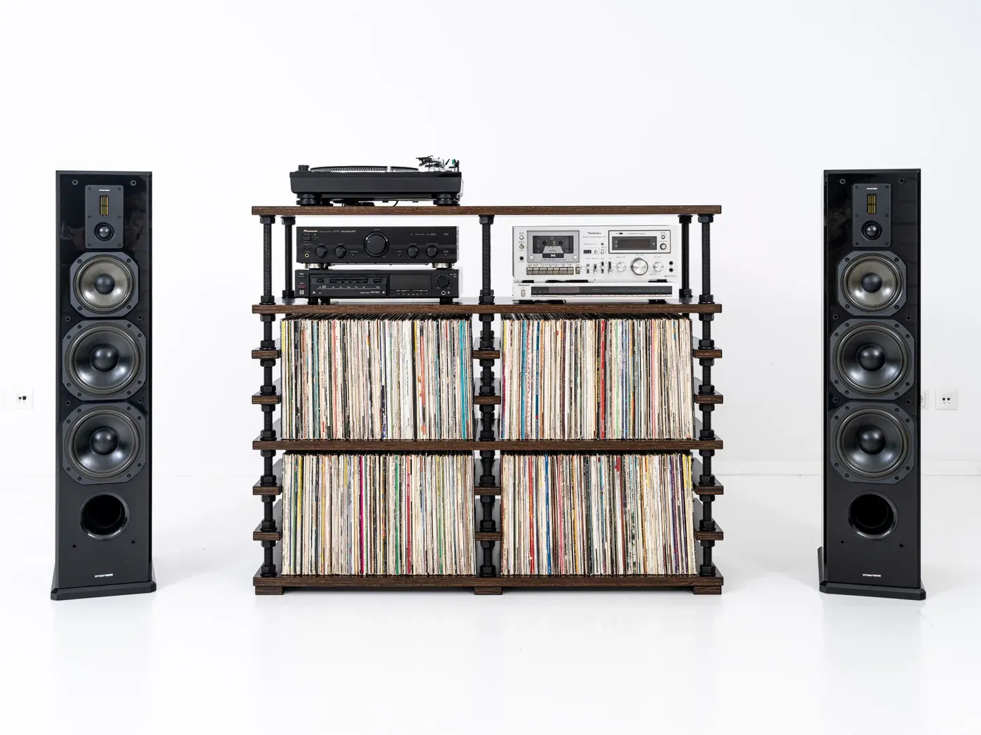 Original studio photo of a turntable and hi-fi stereo system with a record collection on a white background