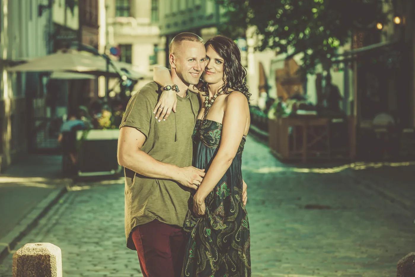 Couple portrait embracing on a cobblestone street in Riga's Old Town