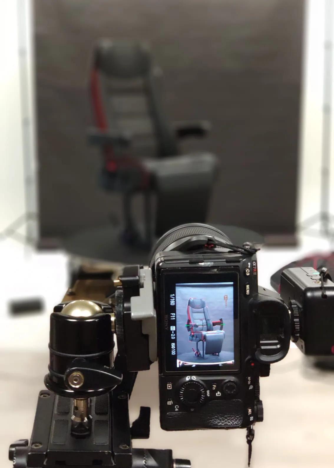 Behind-the-scenes photo of a camera on a rotating rig photographing a chair for 360-degree product photography