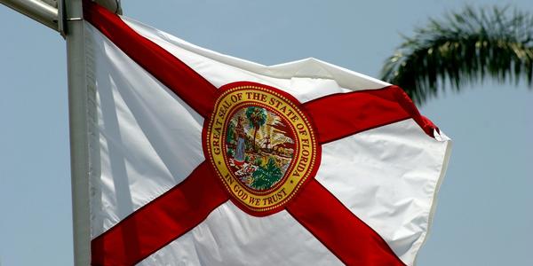 The flag of the state of Florida flying in the wind. Photo by @climatechangevi on Unsplash