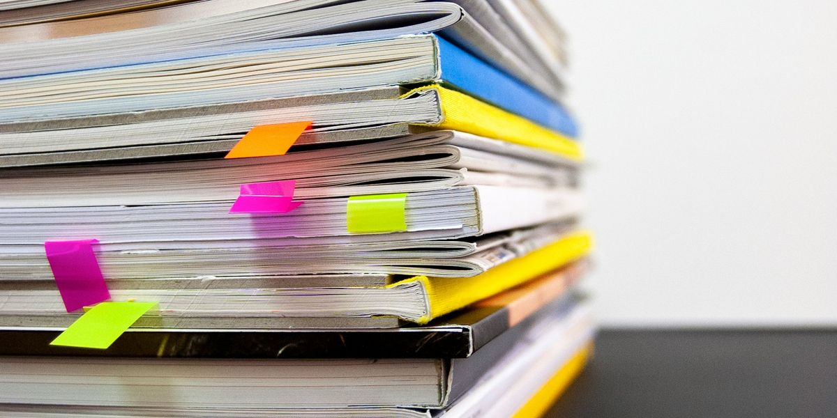 Pile of books with saved tabs. Photo by @bk71 on Unsplash