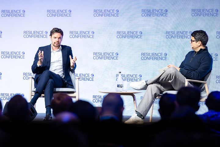 Augur CEO Harry Mead on stage at Resilience London 2026 with Plural founder Khaled Helioui