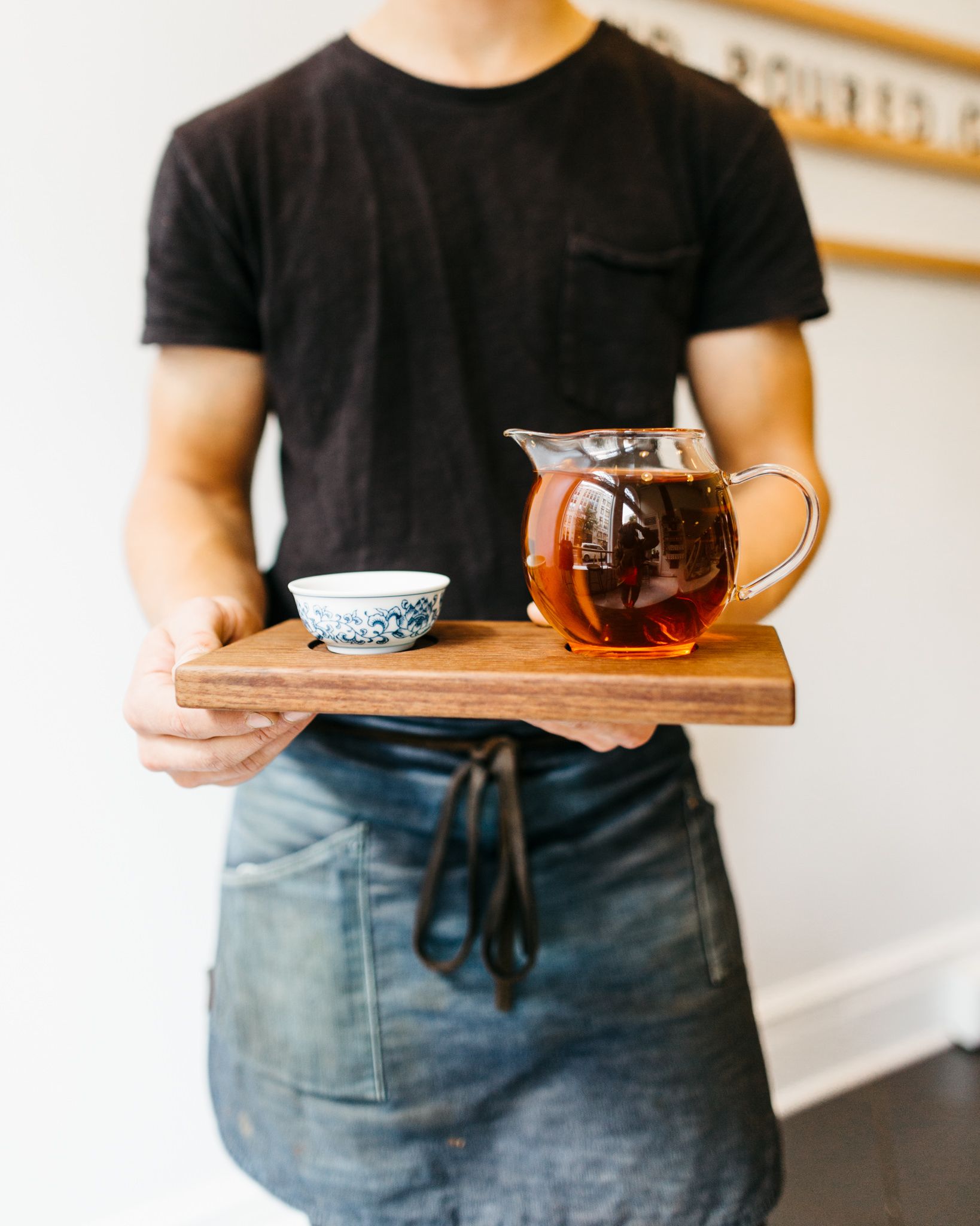 A barista serves a guest tea