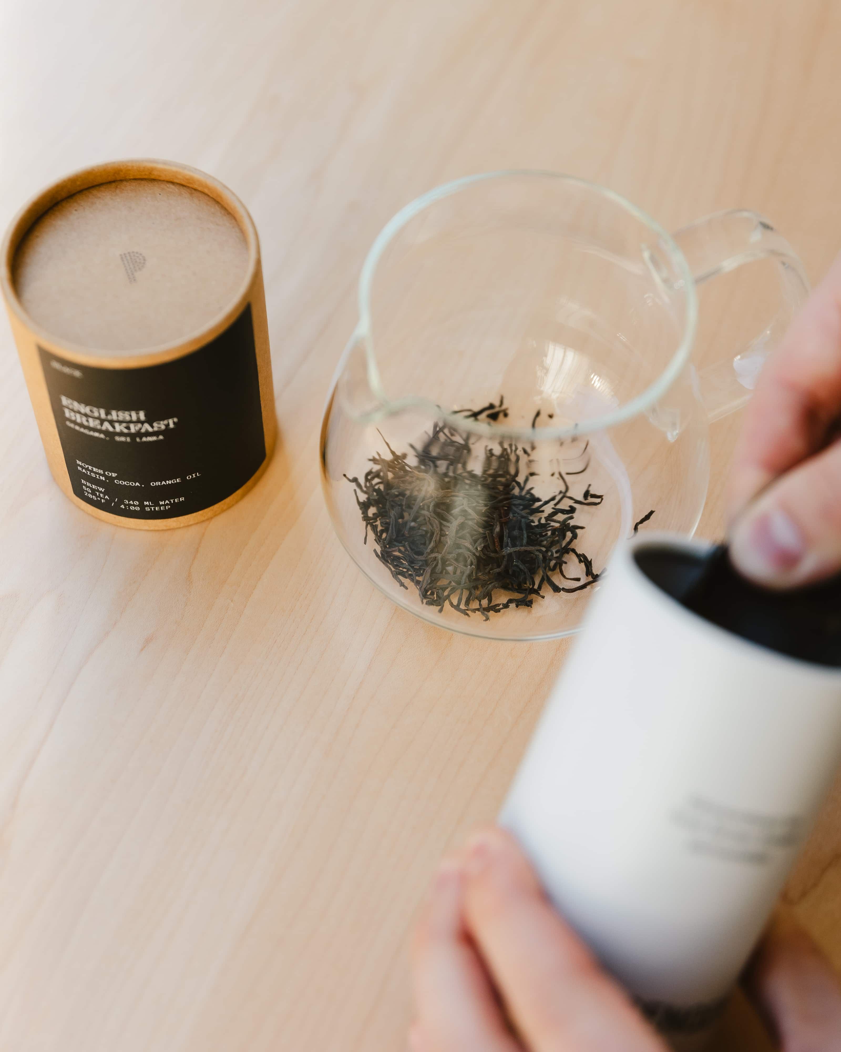 Tea is poured in a vessel for brewing