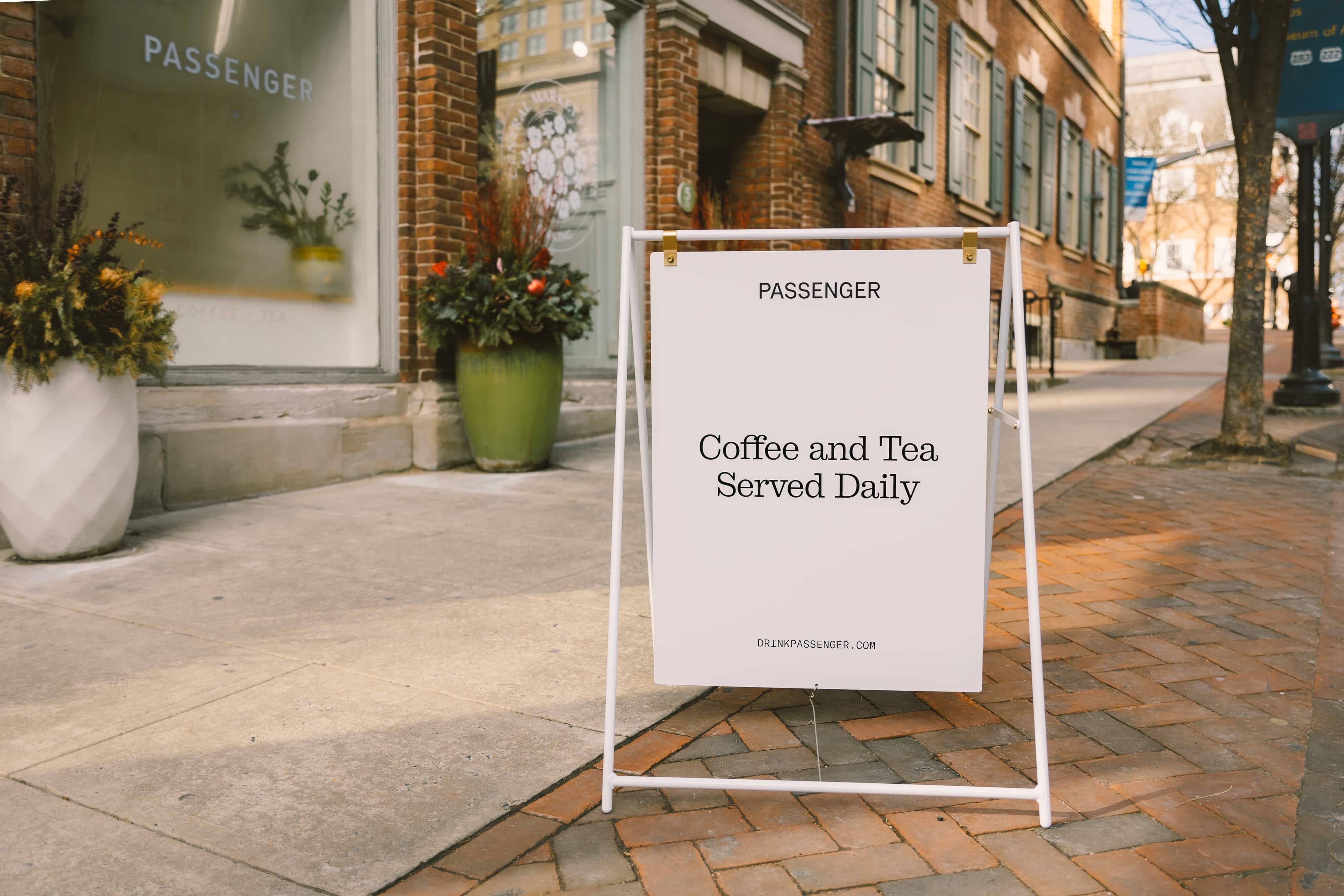 A sidewalk sign outside of Passenger's cafè