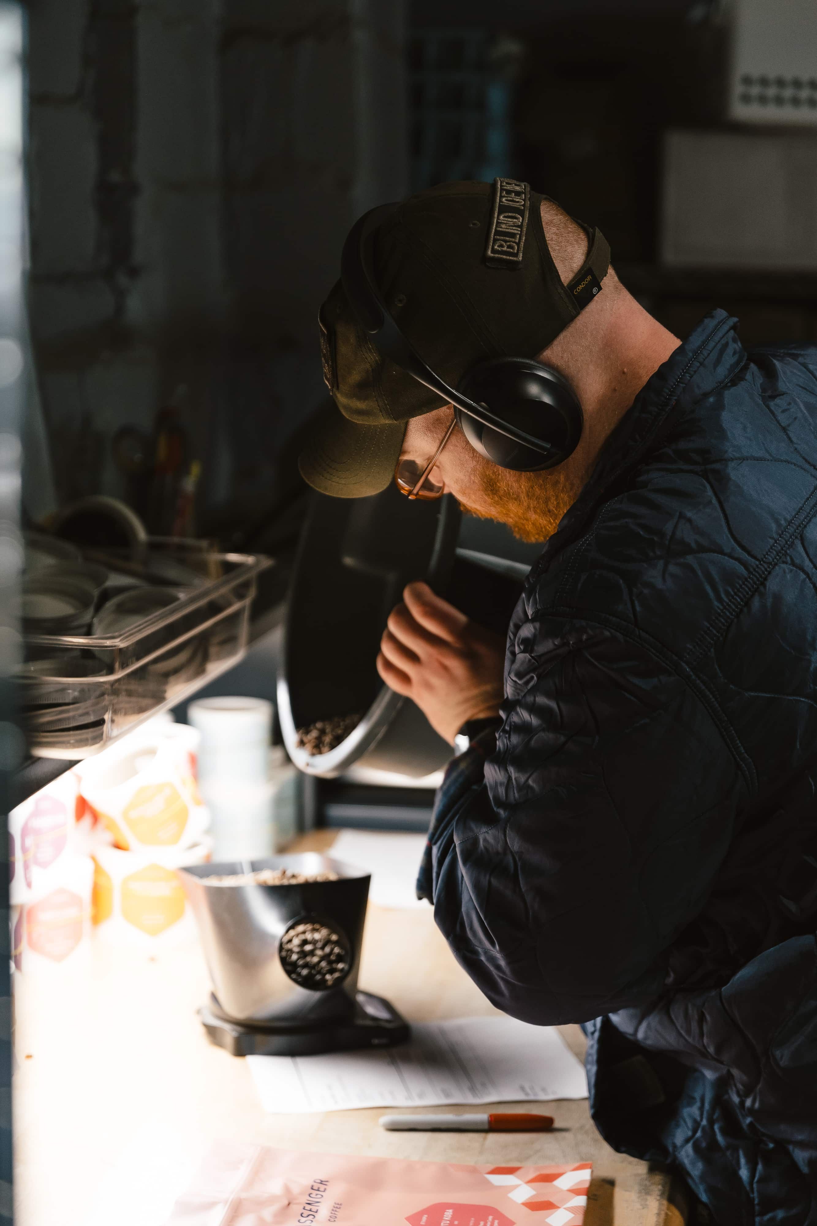 A Passenger team member weighs coffee on a scale