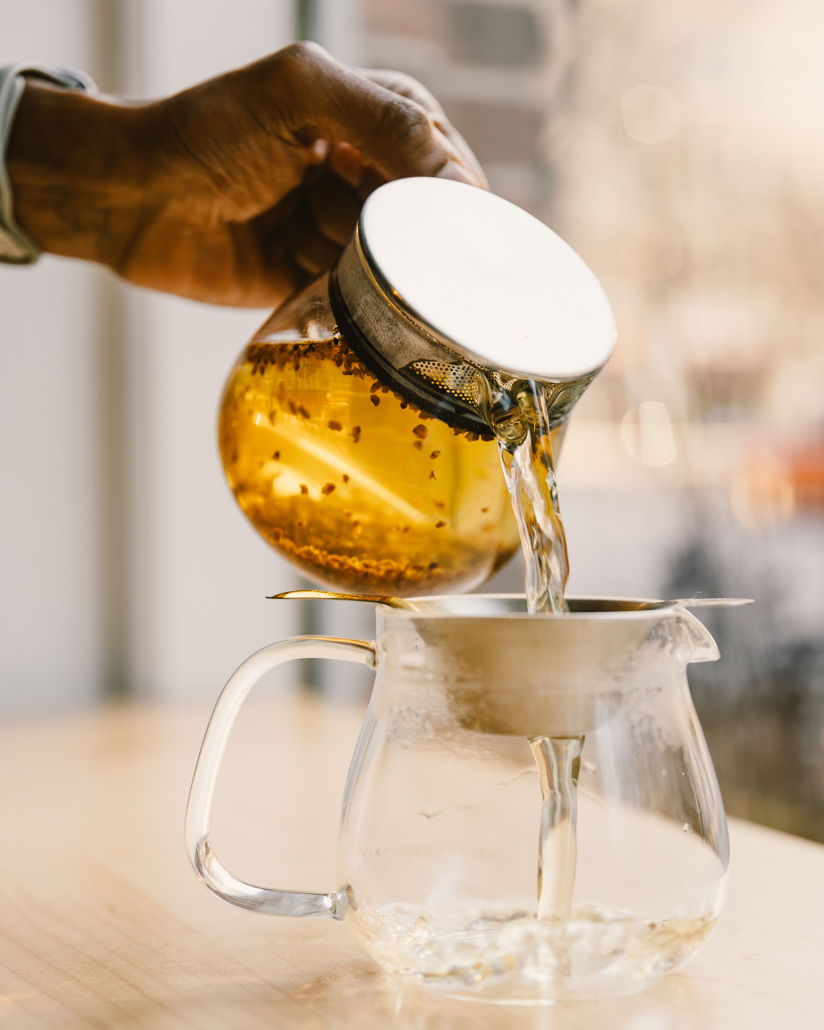 Tea poured into a vessel through a strainer