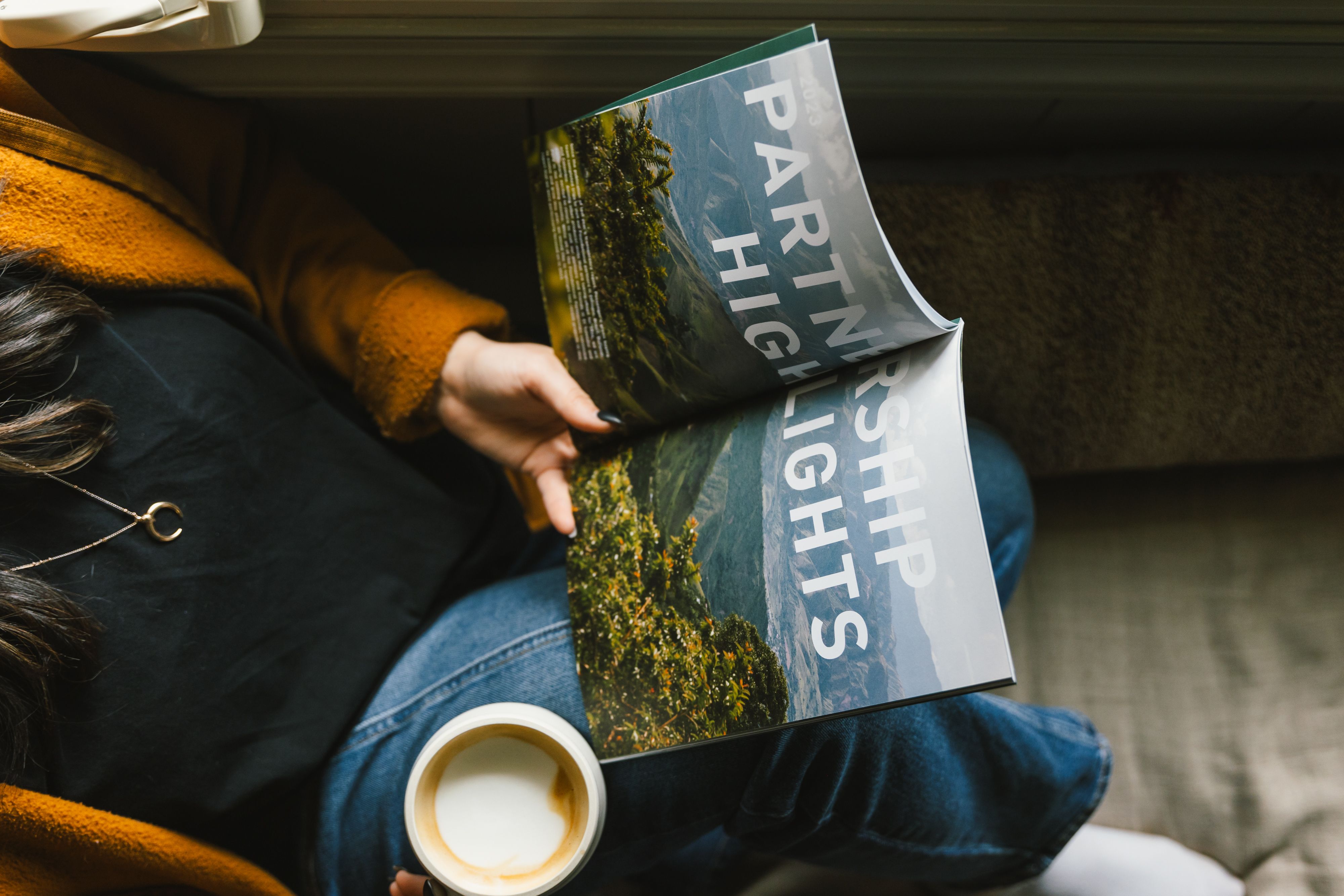 A girl reads the Passenger transparency report while enjoying coffee