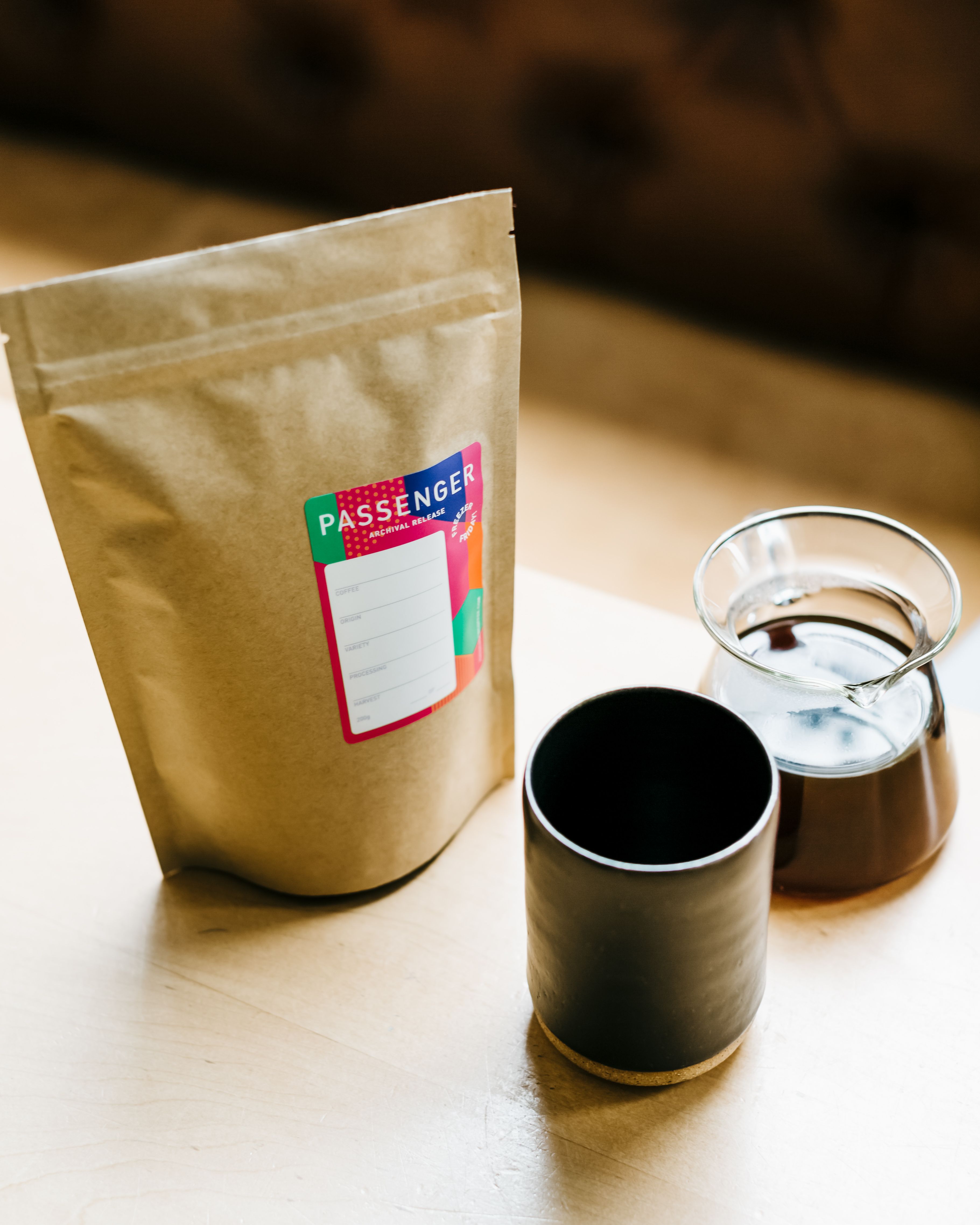 A cup of Passenger's archival release on a table